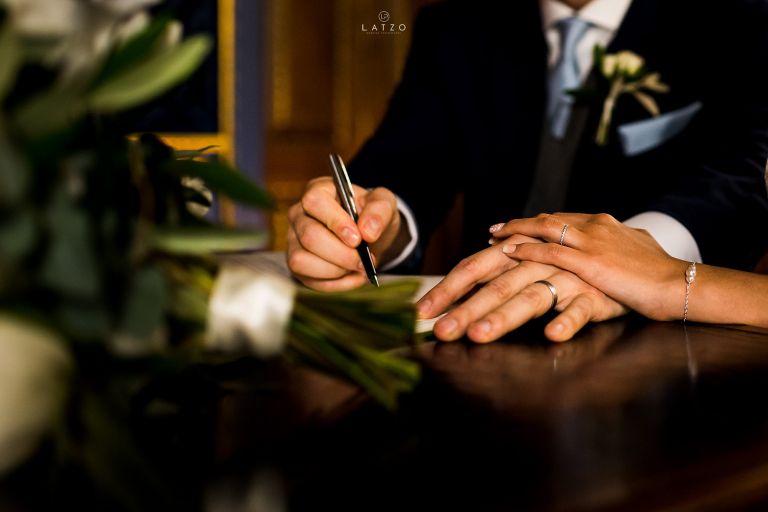 bride and groom signing register London Wedding Chiswick house