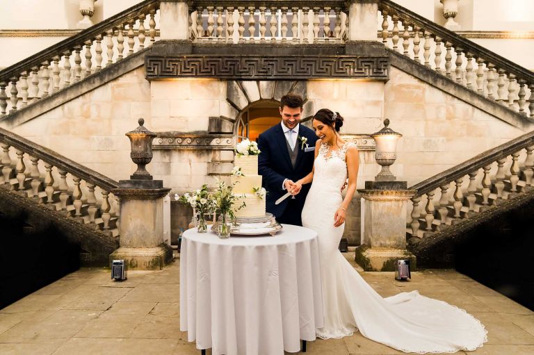 cutting wedding cake London Wedding Chiswick house