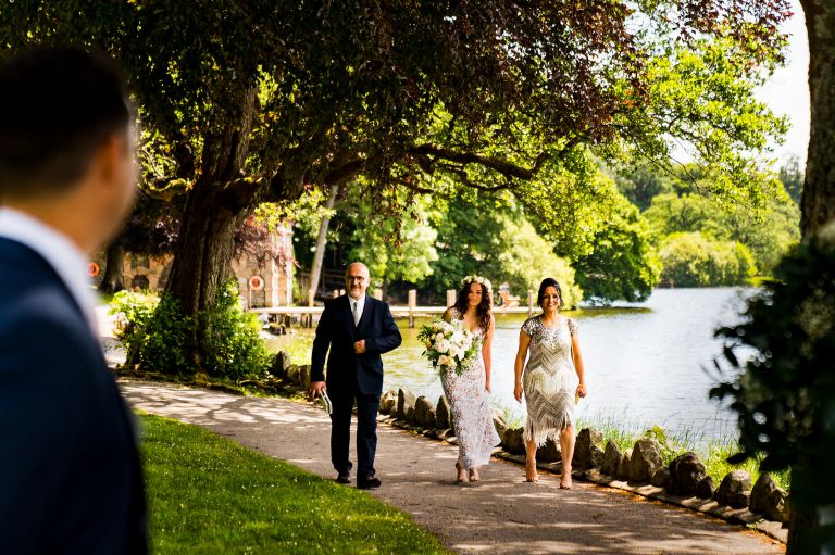 The bride is walking down the aisle at Langdale Chase hotel at lake district