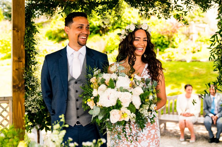 Bride and groom laughing during the wedding ceremony at Lake District wedding 