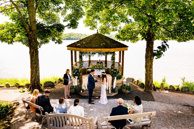 Exchanging wedding rings at lake district lake windermere