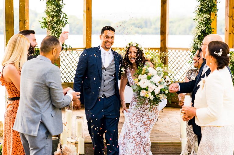 Micro intimate wedding party throwing confetti at Lake district