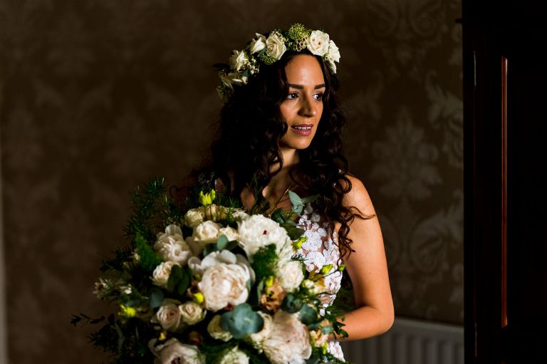 The bride and her flowers at feature room at Langdale hotel