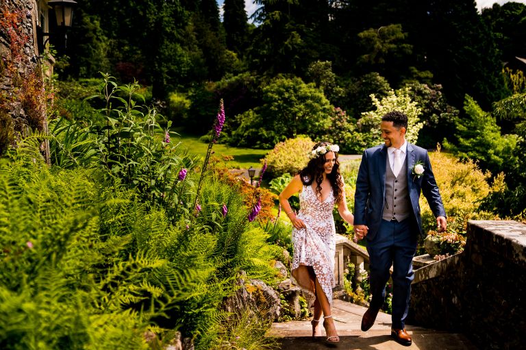 Bride and groom walking upstairs at Langdale Chase hotel