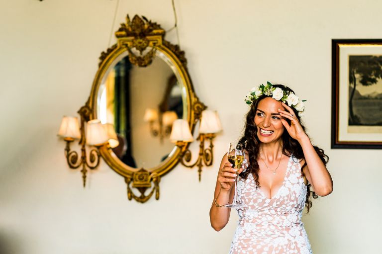 The bride is enjoying her glass of champagne