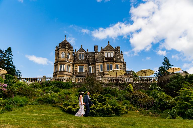 Bride talking to her groom in front of Langdale Chase hotel