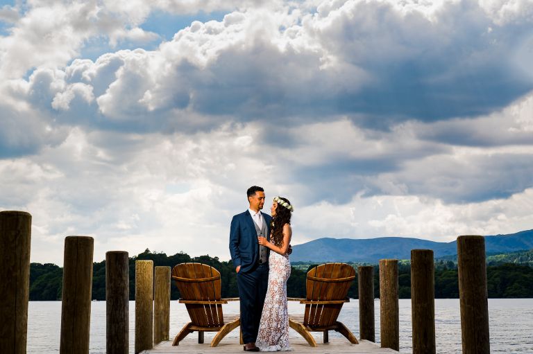 Wedding couple posing on the private jetty at Langdale Chase