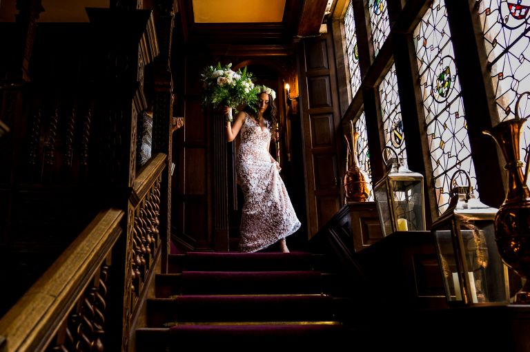 The bride is walking down the stair at Langdale Chase