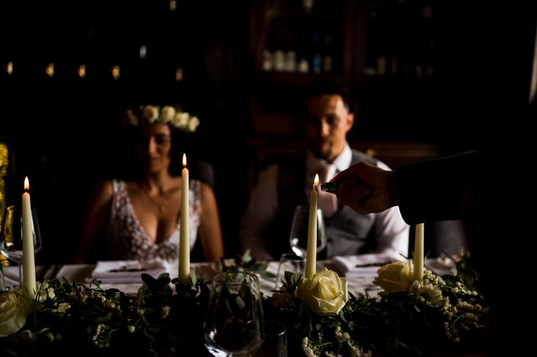 wedding planner lighting the candles before the wedding speech