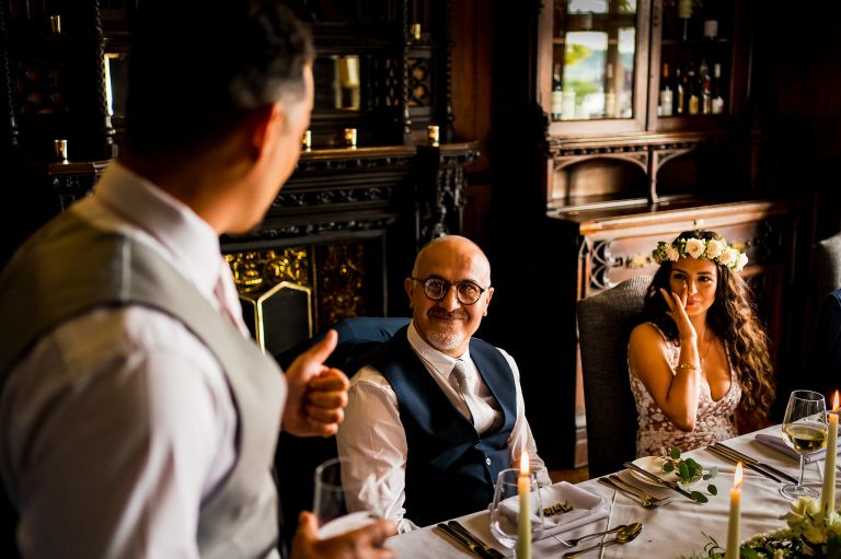 father of the bride is smiling at the groom