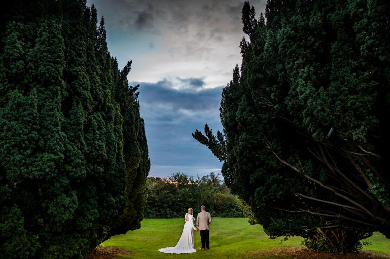 Barton Hall grounds with bride and groom